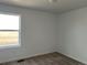 Bedroom featuring carpet and large window with view outdoors at 2025 Barnwood Dr, Brighton, CO 80601