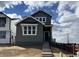 Charming two-story home with gray siding, white trim, and a welcoming front porch under a cloudy blue sky at 2025 Barnwood Dr, Brighton, CO 80601