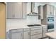 Modern kitchen with gray cabinets, stainless steel appliances, and white hexagon backsplash at 2025 Barnwood Dr, Brighton, CO 80601