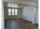 Spacious living room featuring hardwood floors and natural light streaming in through the windows at 2025 Barnwood Dr, Brighton, CO 80601