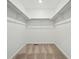 Spacious walk-in closet features ample storage with shelving and neutral carpet at 2025 Barnwood Dr, Brighton, CO 80601