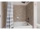 Tiled bathtub and shower combination with a white shower curtain at 9771 Mayfair St # F, Englewood, CO 80112