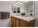 Bathroom featuring a double sink vanity with tile countertop at 9771 Mayfair St # F, Englewood, CO 80112