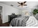 Well-lit bedroom with hardwood floors, a ceiling fan, and a dresser at 9771 Mayfair St # F, Englewood, CO 80112