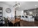 Open-concept dining area with a wooden table, chairs, and a stylish light fixture above at 9771 Mayfair St # F, Englewood, CO 80112