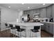 Stylish kitchen with grey cabinetry, stainless steel appliances, and breakfast bar seating at 9771 Mayfair St # F, Englewood, CO 80112