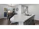 Bright kitchen with a large island featuring a white countertop, stainless steel sink, and modern faucet at 9771 Mayfair St # F, Englewood, CO 80112