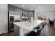 Modern kitchen with stainless steel appliances, quartz countertops, and breakfast bar at 9771 Mayfair St # F, Englewood, CO 80112