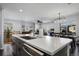 Open kitchen features a white countertop island, stainless steel appliances, and plenty of cabinet space at 9771 Mayfair St # F, Englewood, CO 80112