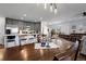 Spacious living room with a wooden table, chairs, and a stylish light fixture above at 9771 Mayfair St # F, Englewood, CO 80112