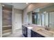 Bright bathroom featuring a double sink vanity, spacious shower, and neutral tones at 23970 E 41St Ave, Aurora, CO 80019