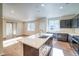 Spacious kitchen featuring an island, dark cabinets, stainless steel appliances, and wood flooring at 23970 E 41St Ave, Aurora, CO 80019