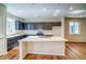Bright kitchen with center island, dark cabinets, stainless appliances, and a white subway tile backsplash at 23970 E 41St Ave, Aurora, CO 80019