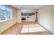 Spacious living area with hardwood flooring, ample natural light, and an open view of the kitchen at 23970 E 41St Ave, Aurora, CO 80019