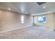 Spacious living room with plush carpeting and multiple windows for natural light at 23970 E 41St Ave, Aurora, CO 80019