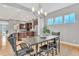 Open-concept dining area featuring modern lighting and seamless flow to kitchen at 82 Oneida St, Denver, CO 80230