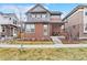 Charming two-story home featuring a brick facade and covered front porch at 82 Oneida St, Denver, CO 80230