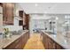 Modern kitchen features stainless steel appliances, granite countertops and dark brown cabinetry at 82 Oneida St, Denver, CO 80230