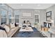 Bright living room boasts modern furniture, a fireplace, and plenty of natural light from large windows at 82 Oneida St, Denver, CO 80230