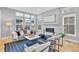 Cozy living room features fireplace, recessed lights, large windows and modern stylish furniture at 82 Oneida St, Denver, CO 80230