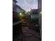 Backyard view featuring stone steps, retaining wall, decorative rock and landscaping lights at 8240 Clayton Ct, Denver, CO 80229