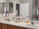Bathroom featuring double sinks, large mirror, and vanity with great storage at 8240 Clayton Ct, Denver, CO 80229
