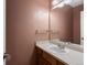 Cozy powder room with a vanity, sink, and a decorative mirror at 8240 Clayton Ct, Denver, CO 80229