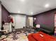 Another view of the secondary bedroom with purple walls, nice carpet and lighting at 8240 Clayton Ct, Denver, CO 80229