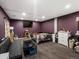 Secondary bedroom with dark purple walls, TV, and carpet at 8240 Clayton Ct, Denver, CO 80229