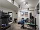 Bright basement exercise room equipped with treadmill, weight bench, mirror and motivational decor at 8240 Clayton Ct, Denver, CO 80229