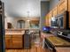 Traditional kitchen featuring wood cabinetry, stainless steel appliances, and backyard view through adjacent breakfast nook at 8240 Clayton Ct, Denver, CO 80229
