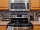 Updated kitchen with stainless steel appliances and backsplash at 8240 Clayton Ct, Denver, CO 80229