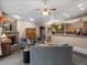 Inviting living room with fireplace, comfortable seating, and a view of the open kitchen at 8240 Clayton Ct, Denver, CO 80229