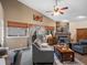 Bright living room with high ceilings, fireplace, backyard view, and comfortable seating at 8240 Clayton Ct, Denver, CO 80229