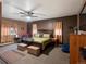 Spacious bedroom with a ceiling fan, a sitting area, neutral carpet, and ample natural light at 8240 Clayton Ct, Denver, CO 80229