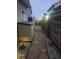 Illuminated backyard walkway with a stone path for peaceful evening strolls at 8240 Clayton Ct, Denver, CO 80229