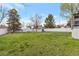 Expansive green backyard with a white fence surrounding the perimeter at 2055 Quail Dr, Lakewood, CO 80215