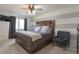 Comfortable bedroom with neutral-toned walls, ceiling fan, large window, and plush carpeting at 2055 Quail Dr, Lakewood, CO 80215