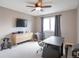 Bedroom or office space with ceiling fan, large window, desk, and neutral-toned walls and carpeting at 2055 Quail Dr, Lakewood, CO 80215