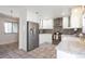 Well-appointed kitchen boasting stainless steel appliances, granite counters, white cabinets, and tile flooring at 2055 Quail Dr, Lakewood, CO 80215