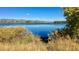 Scenic view of lake with mountains in background at 2055 Quail Dr, Lakewood, CO 80215