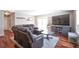 Cozy living room with plush leather seating, hardwood floors, and sliding glass doors for natural light at 2055 Quail Dr, Lakewood, CO 80215