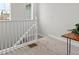 Hallway featuring white railing and neutral carpet leading to the upper level at 2591 Iola St, Aurora, CO 80010