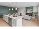 Modern kitchen open to the living area features stainless appliances and a large center island at 2591 Iola St, Aurora, CO 80010