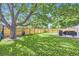 Expansive backyard with a privacy fence, mature tree with hammock, and well-kept lawn at 6995 W 27Th Ave, Wheat Ridge, CO 80033