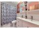 Bright bathroom boasts a stylish double vanity, updated lighting, updated faucet fixtures, and charming shower at 6995 W 27Th Ave, Wheat Ridge, CO 80033