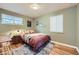 Comfortable bedroom features a large window with great light, hardwood floors, and ample space at 6995 W 27Th Ave, Wheat Ridge, CO 80033