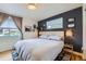 Modern bedroom boasts stylish accent wall, large window, and hardwood floors at 6995 W 27Th Ave, Wheat Ridge, CO 80033