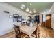 Bright dining area with a wooden table, hardwood floors, designer lighting, and easy access to the kitchen at 6995 W 27Th Ave, Wheat Ridge, CO 80033