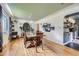 Bright dining area with a wooden table, hardwood floors, designer lighting, and easy access to the open-concept kitchen at 6995 W 27Th Ave, Wheat Ridge, CO 80033